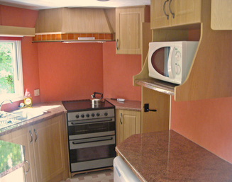 Spacious kitchen with lots of storage in luxury holiday caravan