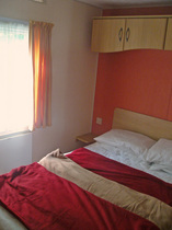 Comfortable double bedroom in luxury holiday caravan